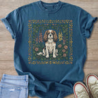T-shirt with Cavalier King Charles Spaniel dog sitting amidst floral border art.