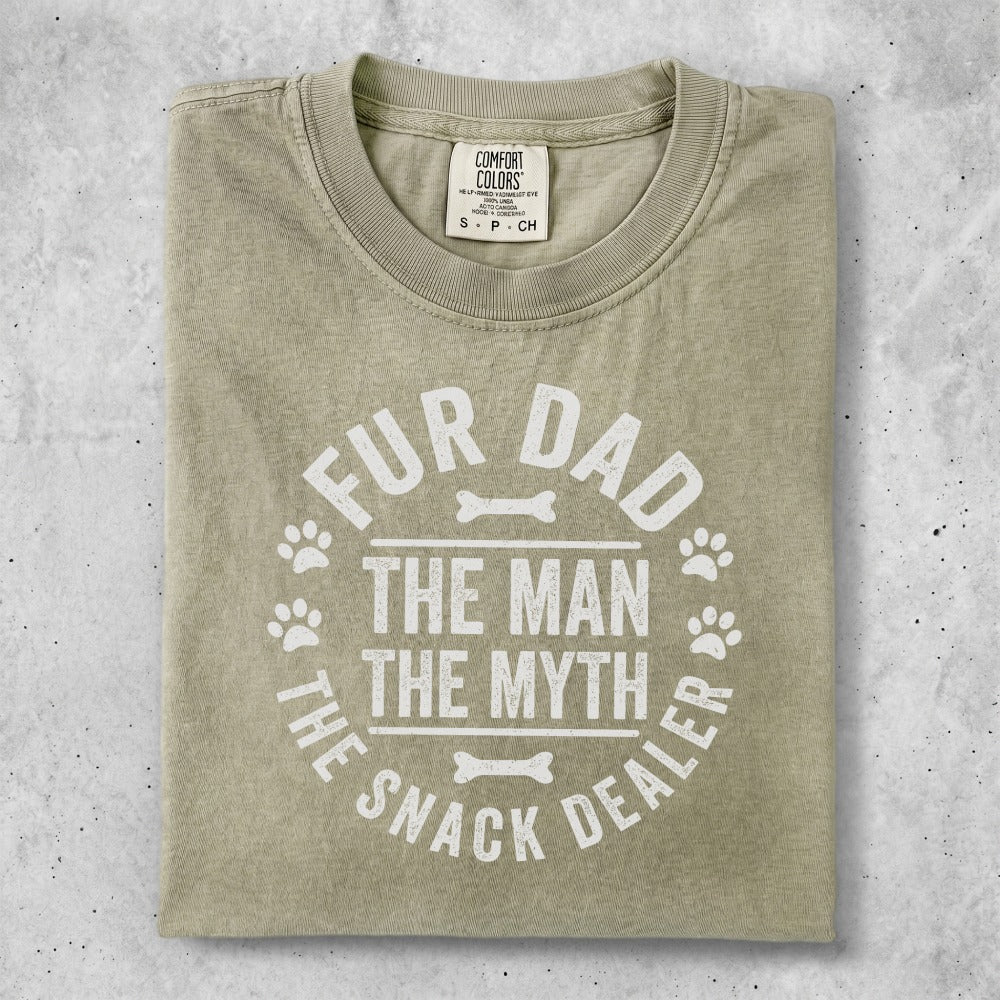 T-shirt with "Fur Dad, The Man, The Myth, The Snack Dealer" text and paw prints.