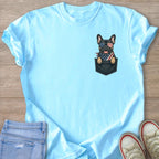 French bulldog in pocket graphic with American flag bandana and sunglasses on light blue t-shirt.
