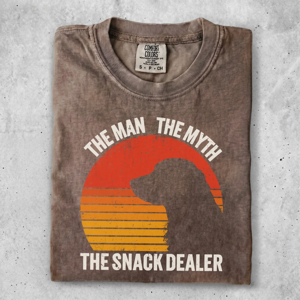 T-shirt with "The Man The Myth The Snack Dealer" text and dog silhouette.