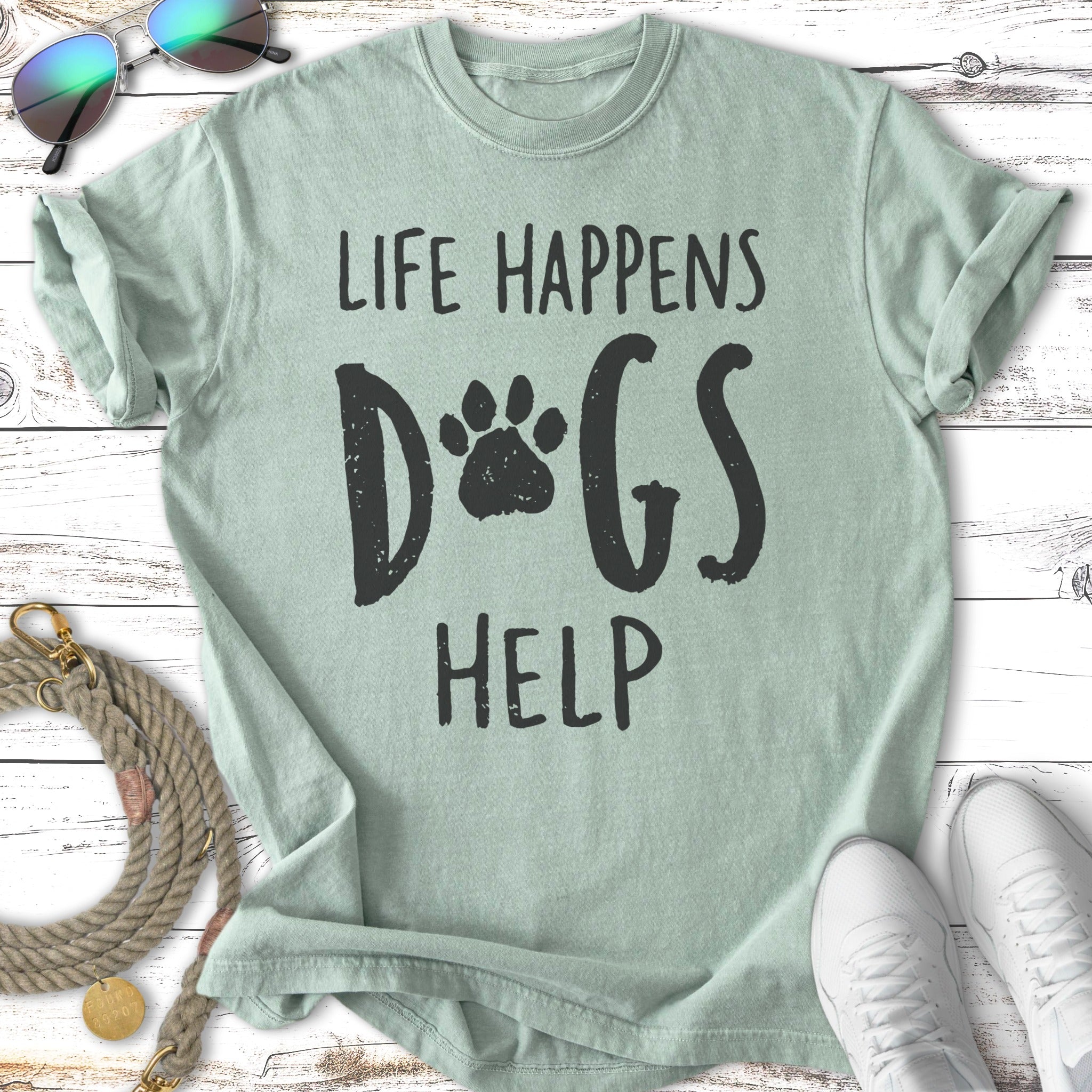 Pale green t-shirt with "Life Happens Dogs Help" and paw print graphic.