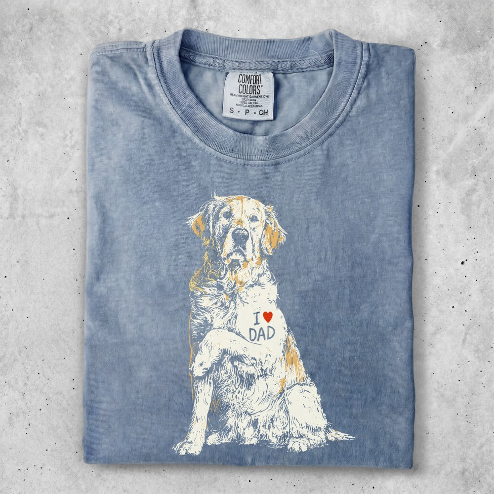 Golden Retriever wearing a shirt with "I ❤️ DAD" printed on it.
