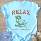 Light blue t-shirt with "RELAX" above a dog wearing a cowboy hat relaxing in a chair.