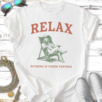 T-shirt with dog relaxing in a chair, text "RELAX NOTHING IS UNDER CONTROL".