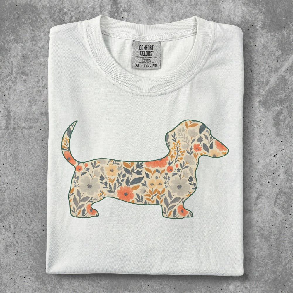 White t-shirt featuring a floral dachshund silhouette.