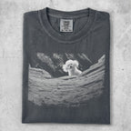Dark gray t-shirt with white poodle peeking from behind rocks graphic.