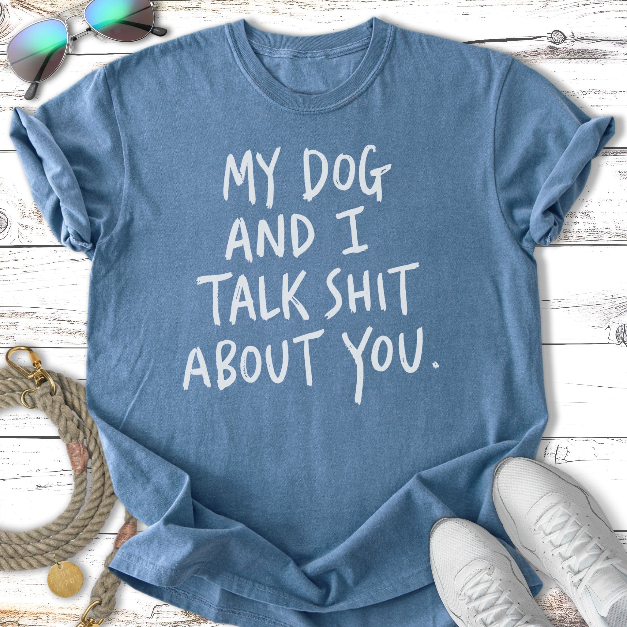 Blue t-shirt with "My dog and I talk shit about you." text.