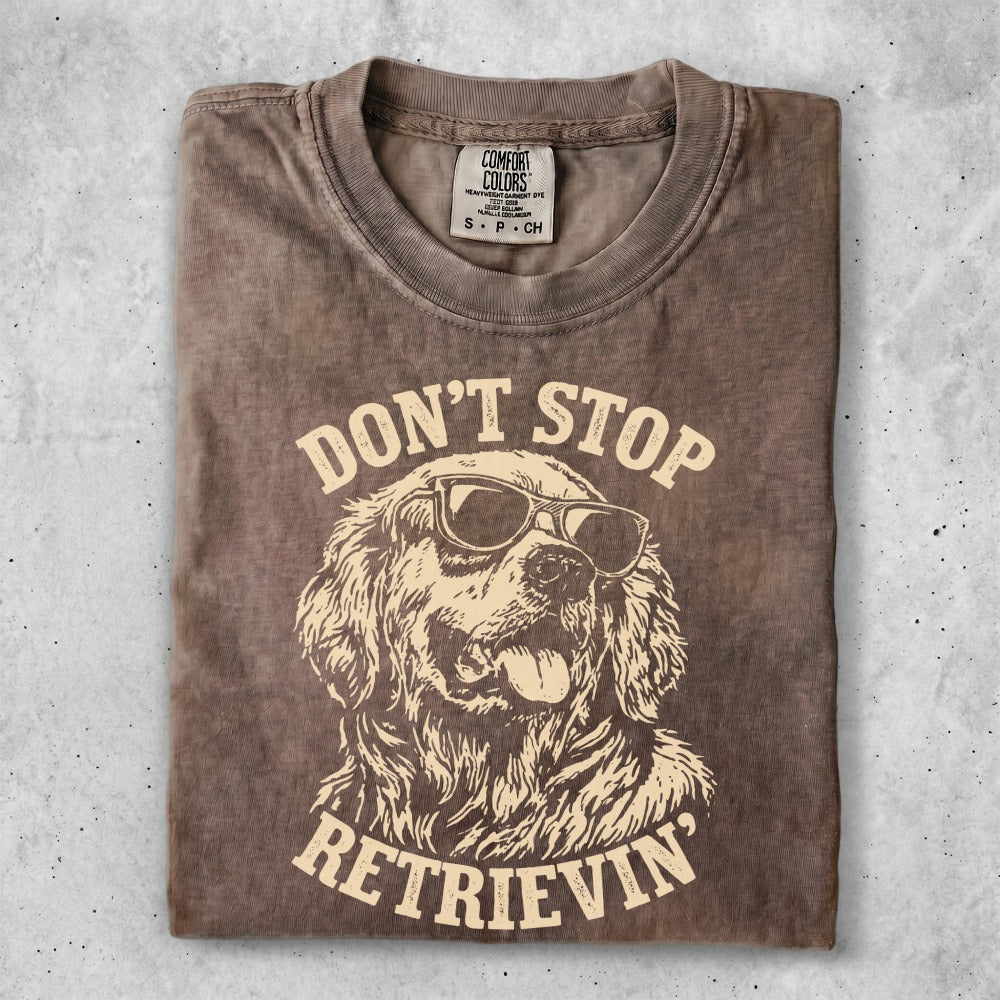 Brown t-shirt with graphic of golden retriever wearing sunglasses and text "DON'T STOP RETRIEVIN'".