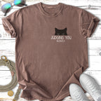 Brown t-shirt with black cat peeking and text "JUDGING YOU SILENTLY".