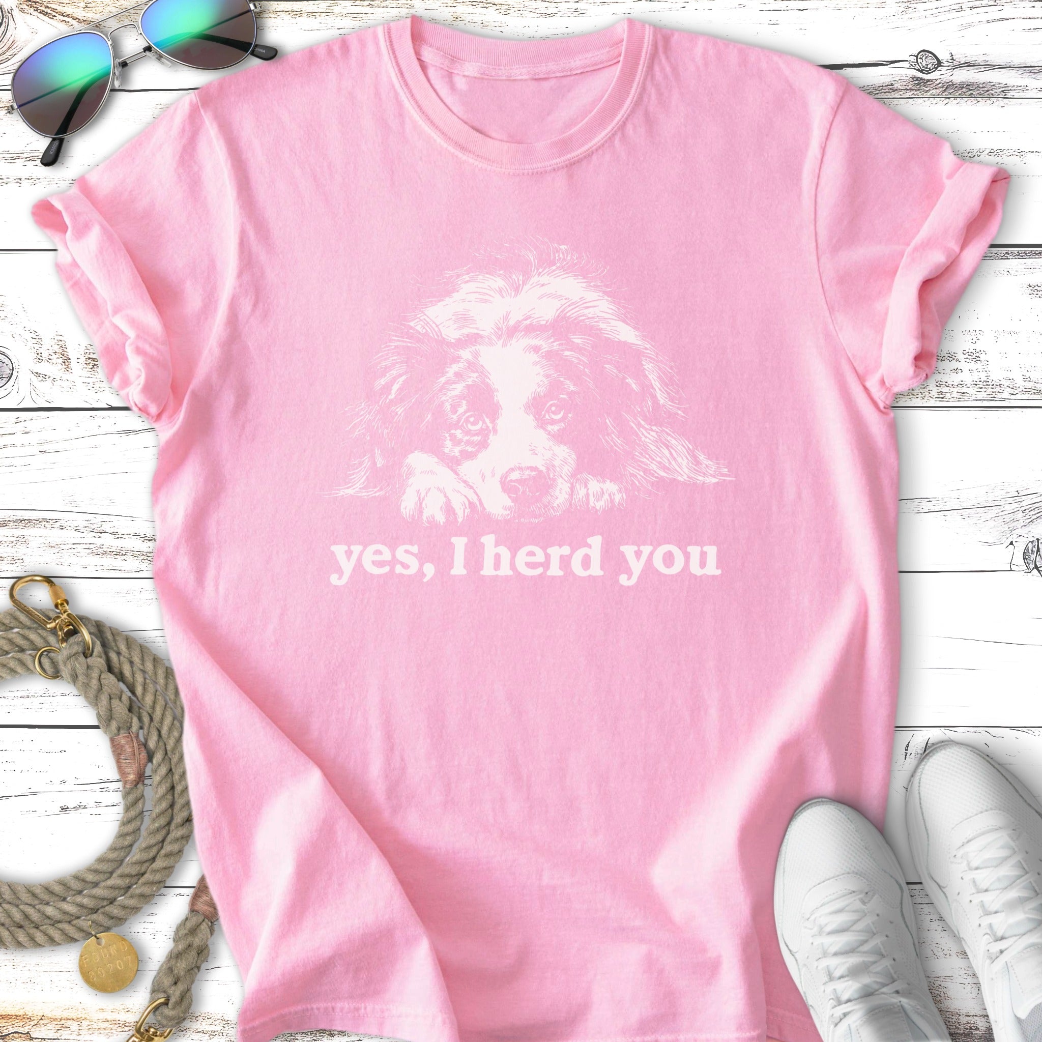 Pink t-shirt with a white outline of a dog's head and "yes, I herd you" text.