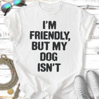 White t-shirt with "I'M FRIENDLY, BUT MY DOG ISN'T" text in black.