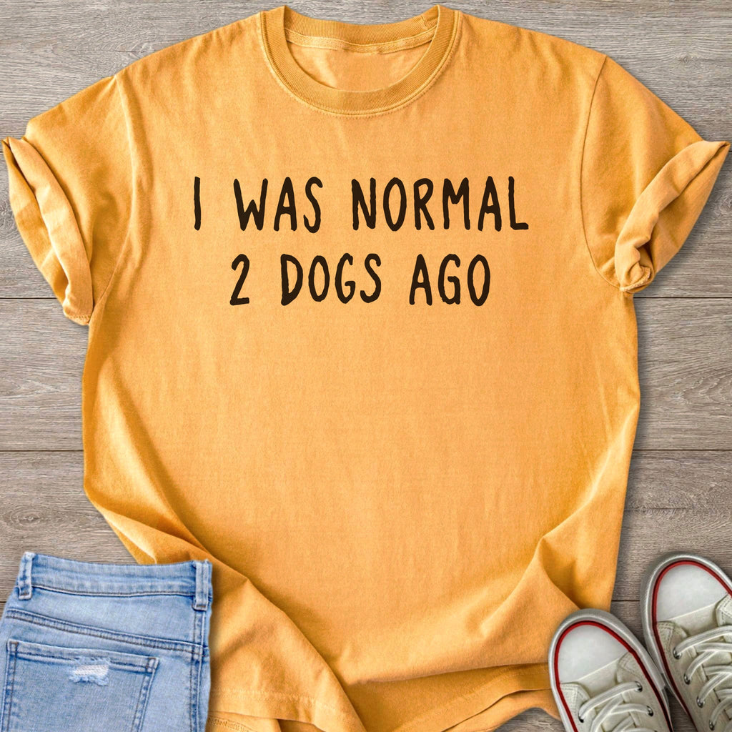 Orange t-shirt with black text "I WAS NORMAL 2 DOGS AGO".