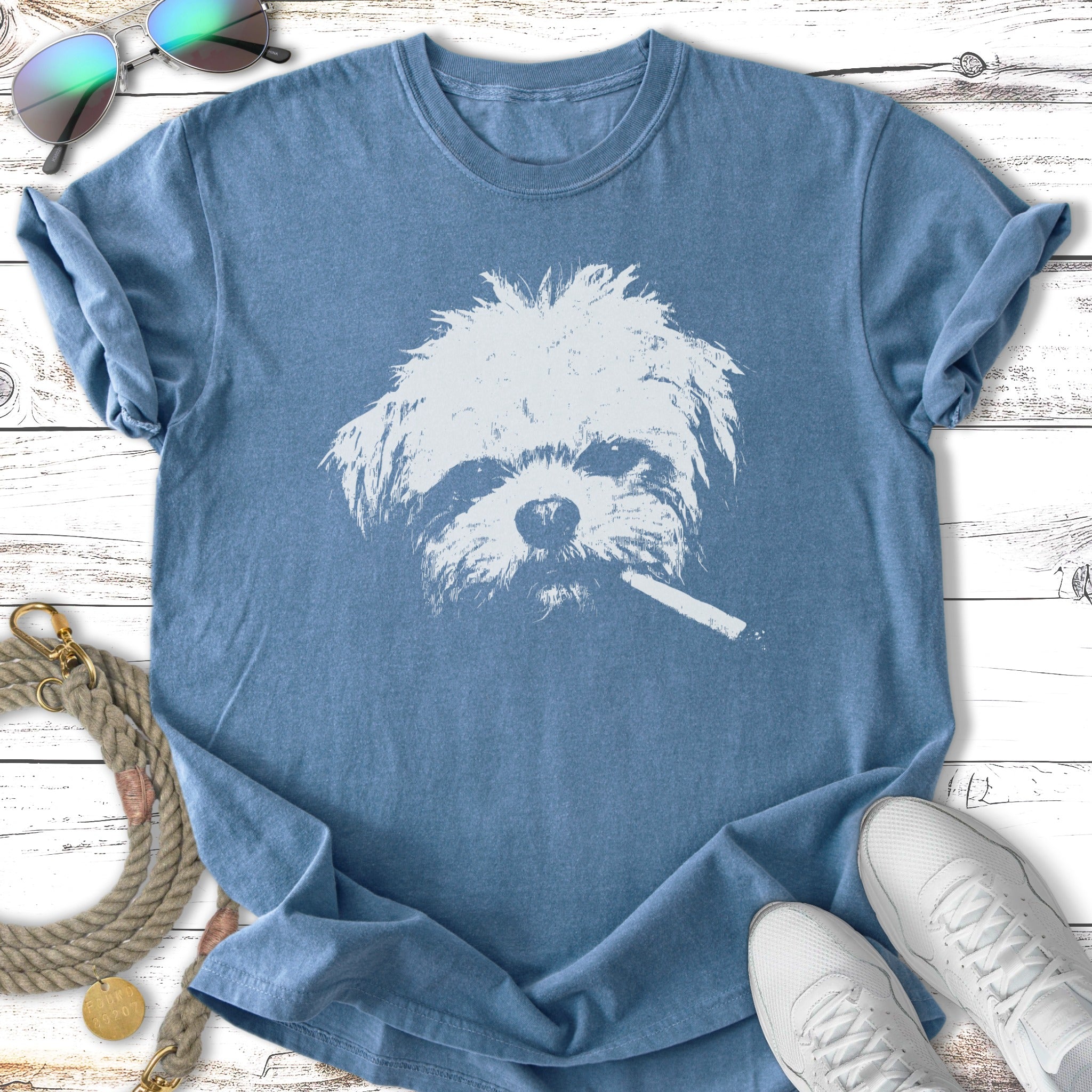 Blue t-shirt featuring a white distressed graphic of a dog with a cigarette.