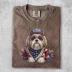 Dog wearing sunglasses and a bandana, with "USA" hat and patriotic decorations.