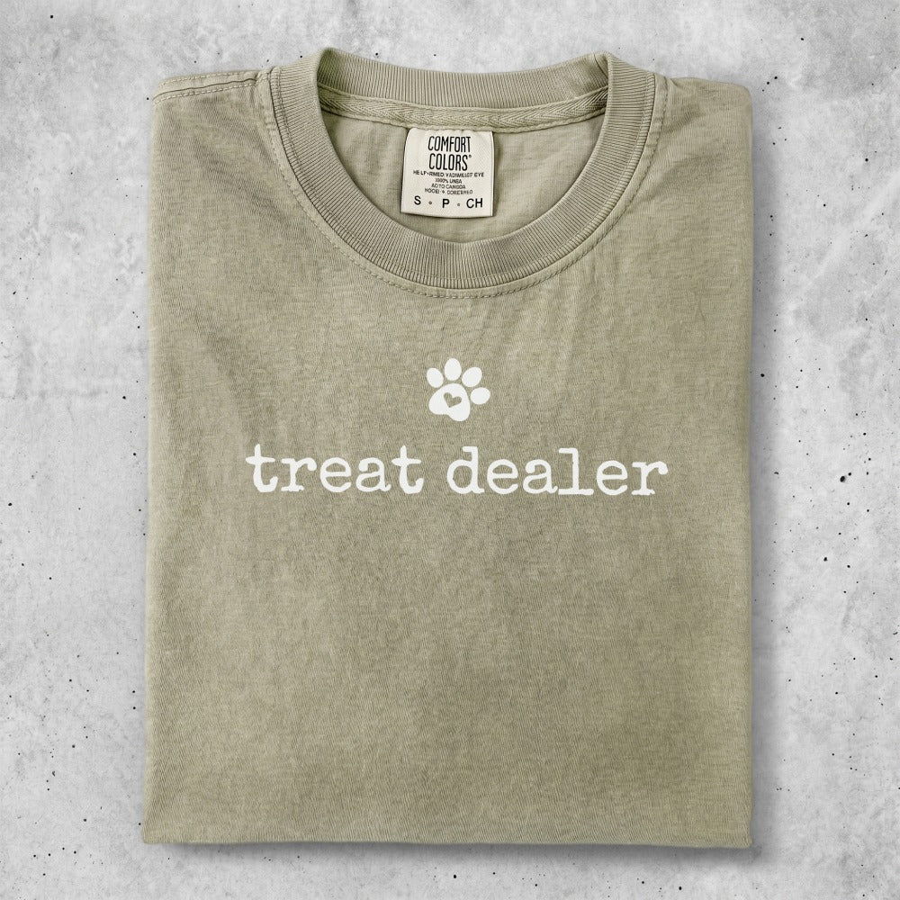 Comfort Colors t-shirt with "treat dealer" and paw print graphic.