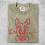 German Shepherd with rose in mouth on light olive green t-shirt.