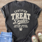 Dark grey t-shirt with "CERTIFIED TREAT DEALER" and paw print graphic.