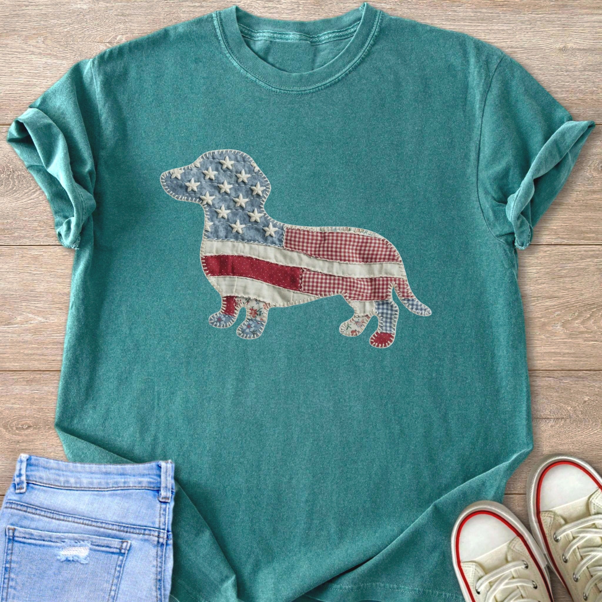 Teal t-shirt with a dachshund outline filled with American flag-themed patchwork fabric.