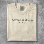 Cream t-shirt with "coffee & dogs." and paw prints graphic.