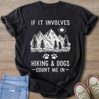 Black t-shirt with mountains, trees, sun, and text "If it involves hiking & dogs - count me in".