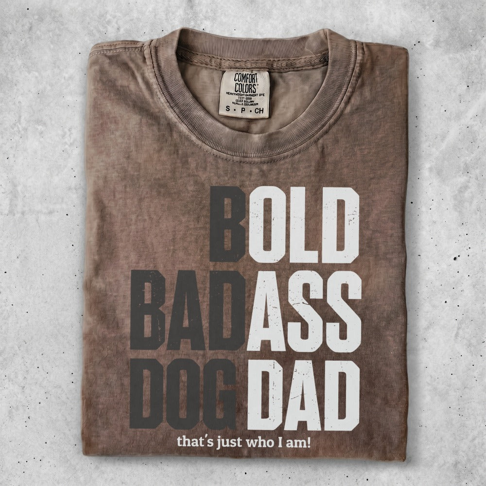 Brown t-shirt with bold white text: "BOLD BADASS DOG DAD that's just who I am!".