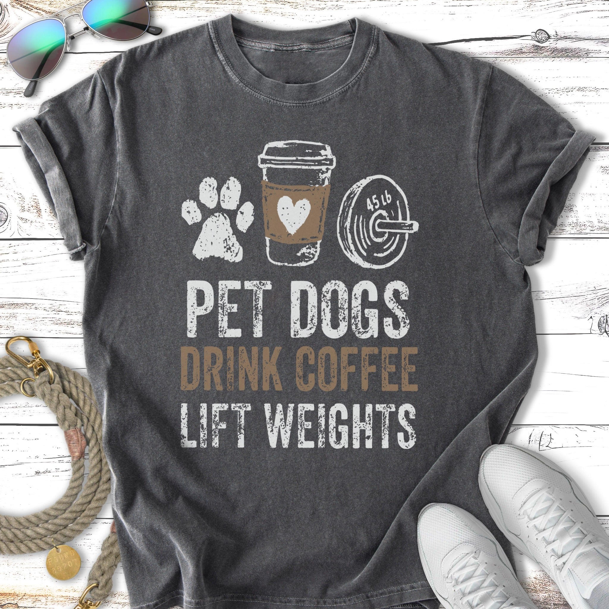 T-shirt with text "Pet Dogs Drink Coffee Lift Weights" and graphics.