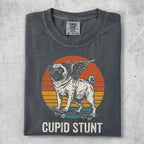 Pug with wings on a skateboard, sunset graphic, "Cupid Stunt" text.
