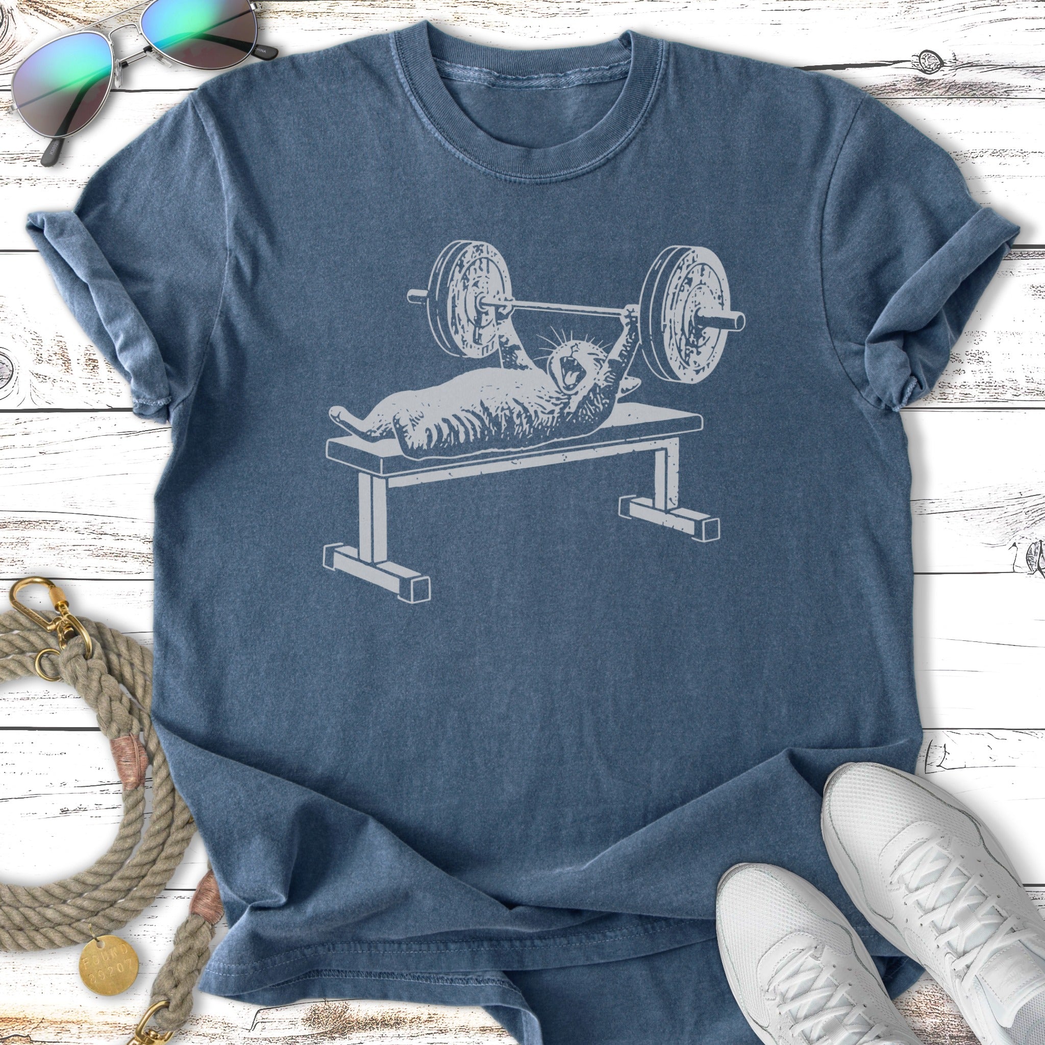T-shirt with a cat lifting weights on a bench press.