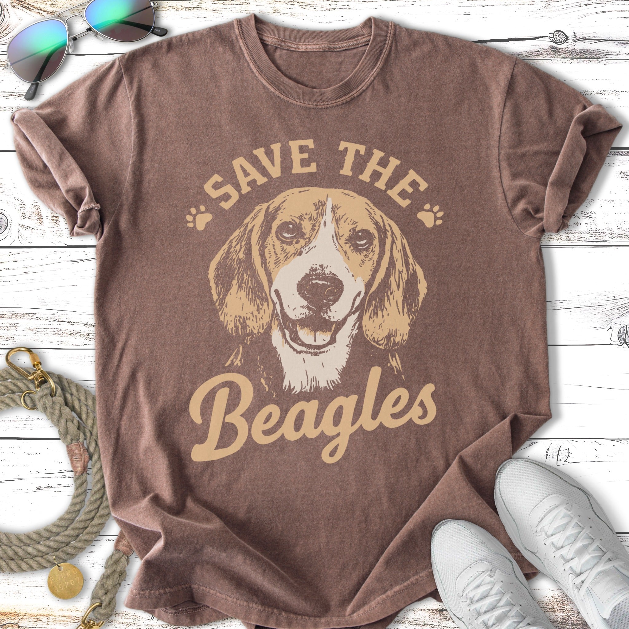 Beagle dog graphic with "Save the Beagles" text on brown t-shirt.