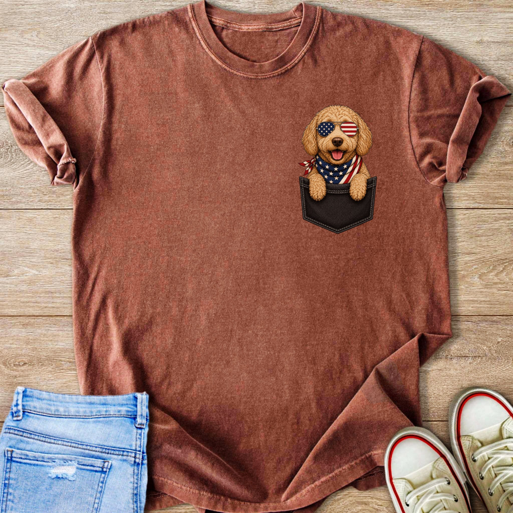 T-shirt with a dog wearing American flag sunglasses and bandana in its pocket.