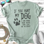 Pale green t-shirt with paw print and bold text "If you hurt my dog I can make your death look like an accident."