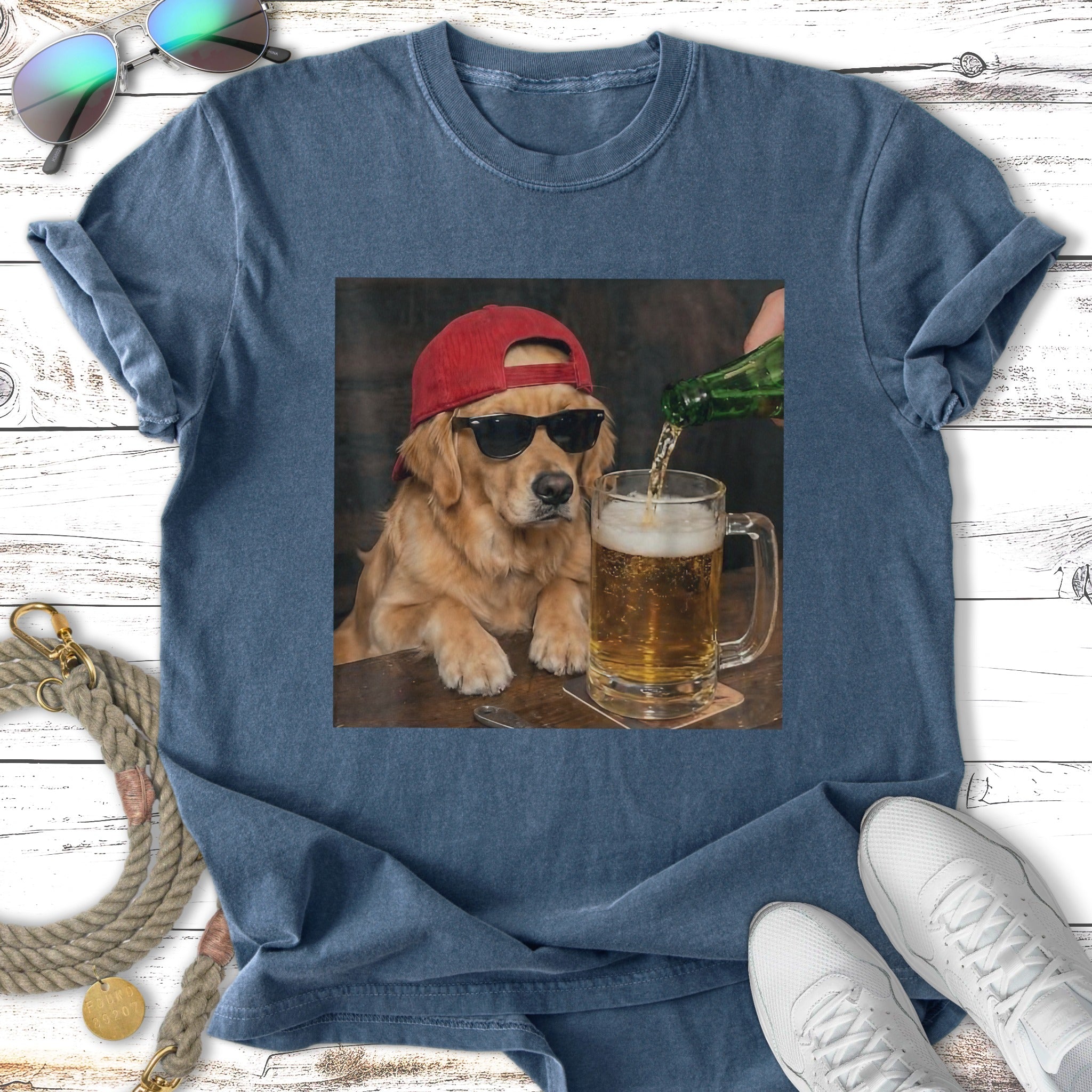 Golden retriever wearing sunglasses and red hat pours beer into glass.
