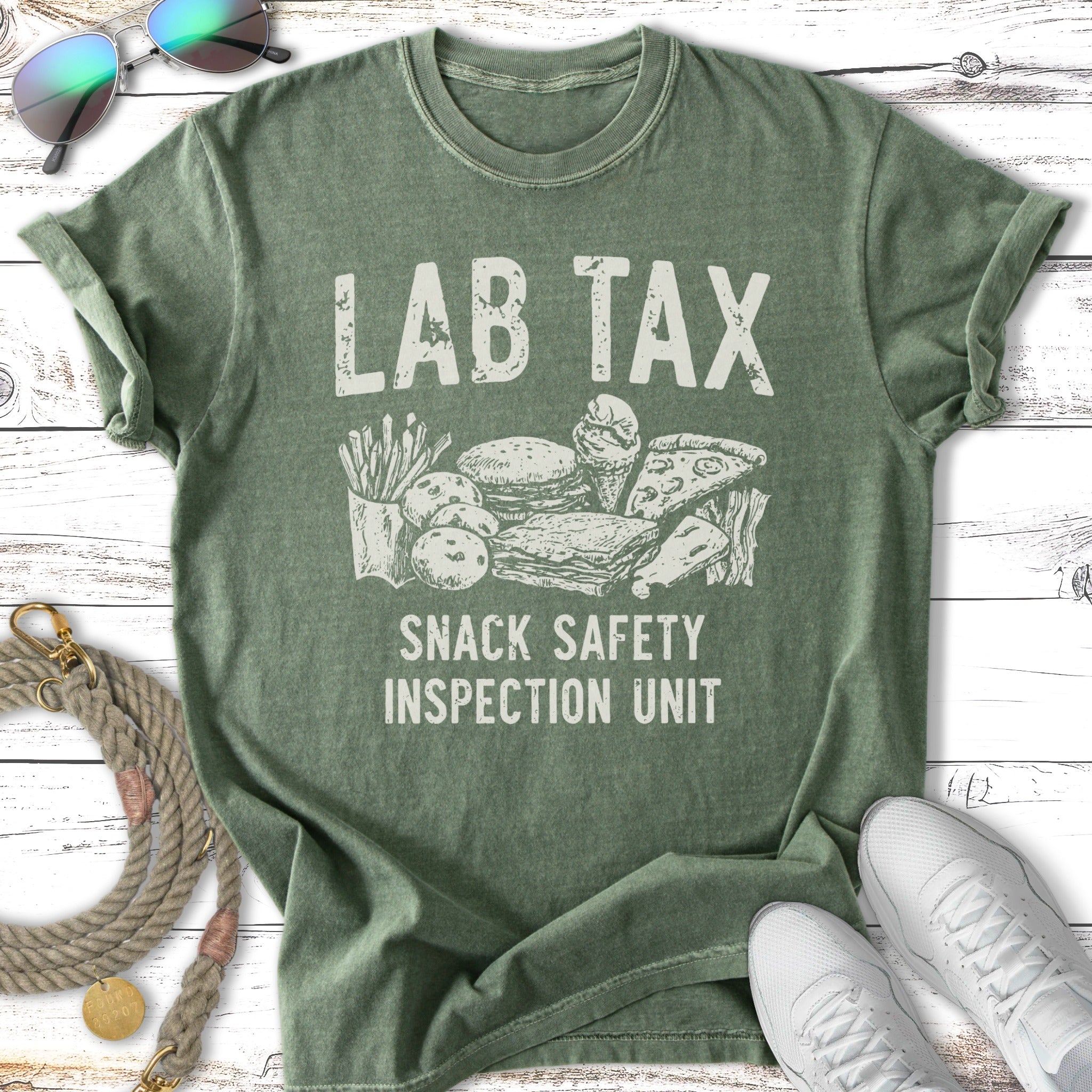 Green t-shirt with "LAB TAX SNACK SAFETY INSPECTION UNIT" and cartoon snacks.
