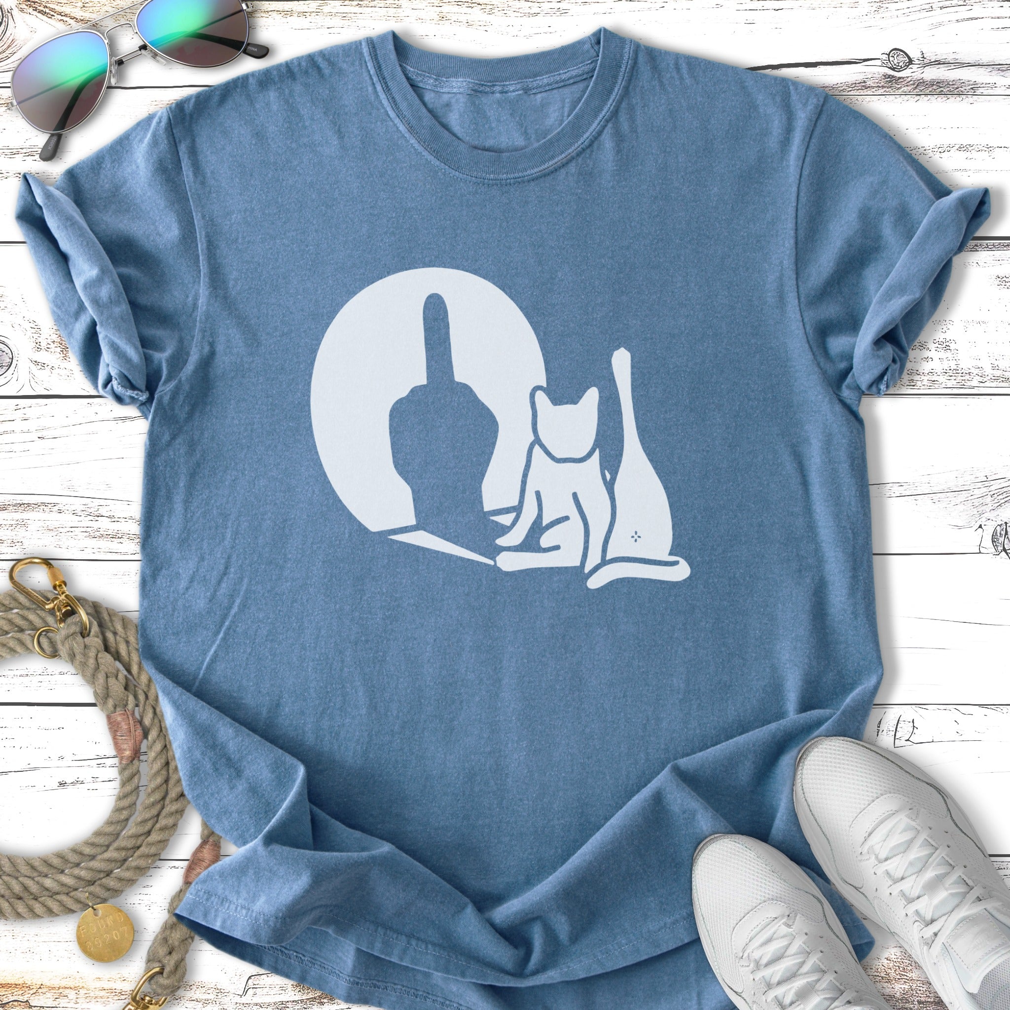T-shirt with a silhouette of a cat giving the middle finger, set against a moon.