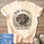 Dachshund in pink heart sunglasses surrounded by flowers with text "More Weenies Less Meanies."