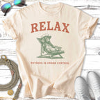 Cream t-shirt with dog on lounge chair and text "RELAX NOTHING IS UNDER CONTROL".