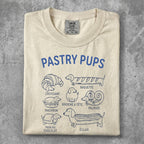 Pastry Pups t-shirt featuring illustrations of croissants, macarons, baguettes, and éclairs.