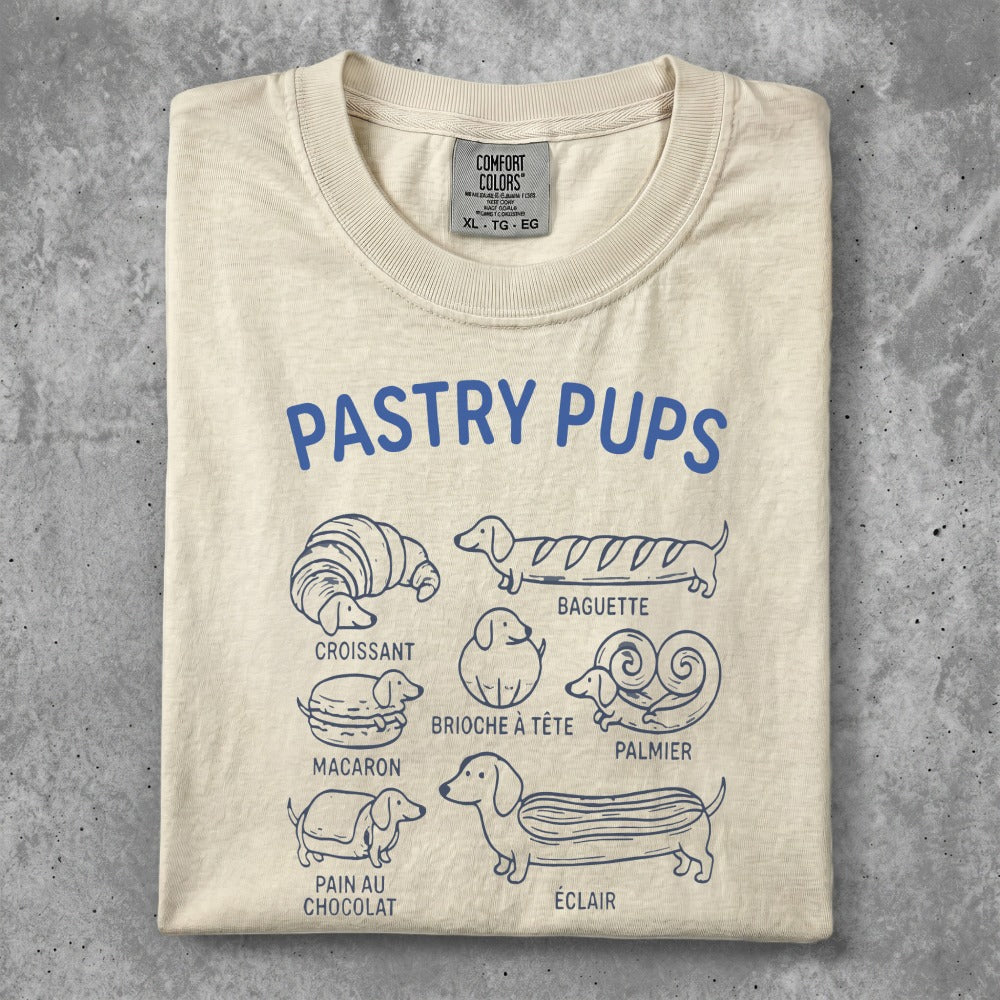 Pastry Pups t-shirt featuring illustrations of croissants, macarons, baguettes, and éclairs.