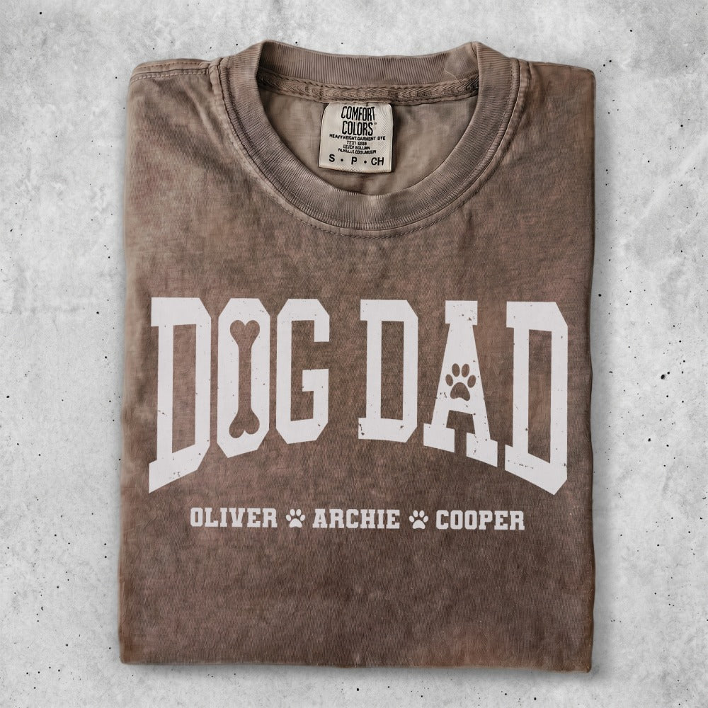 Brown t-shirt with "Dog Dad" and paw print graphic.