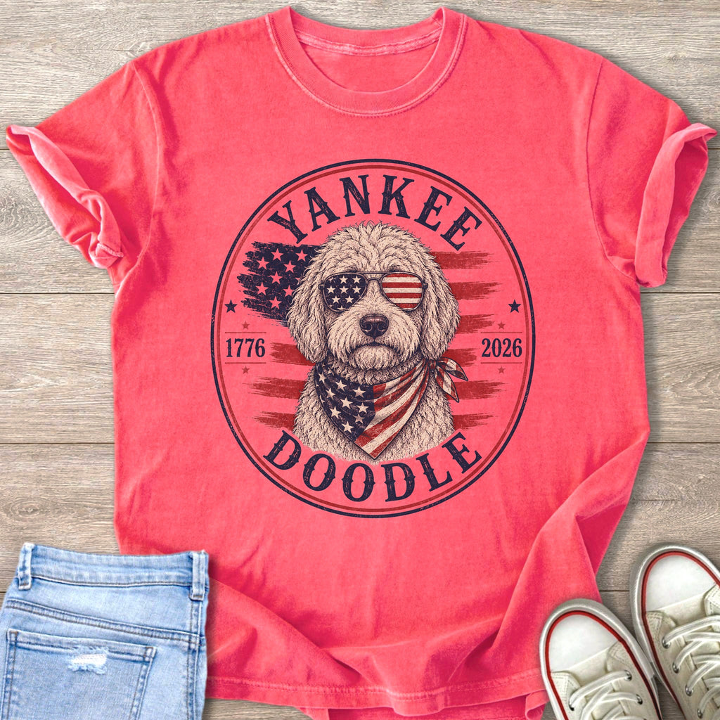 Pink t-shirt with a doodle wearing sunglasses and bandana with American flag design.