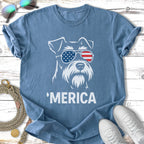 Schnauzer wearing American flag sunglasses, 'MERICA text on blue t-shirt.