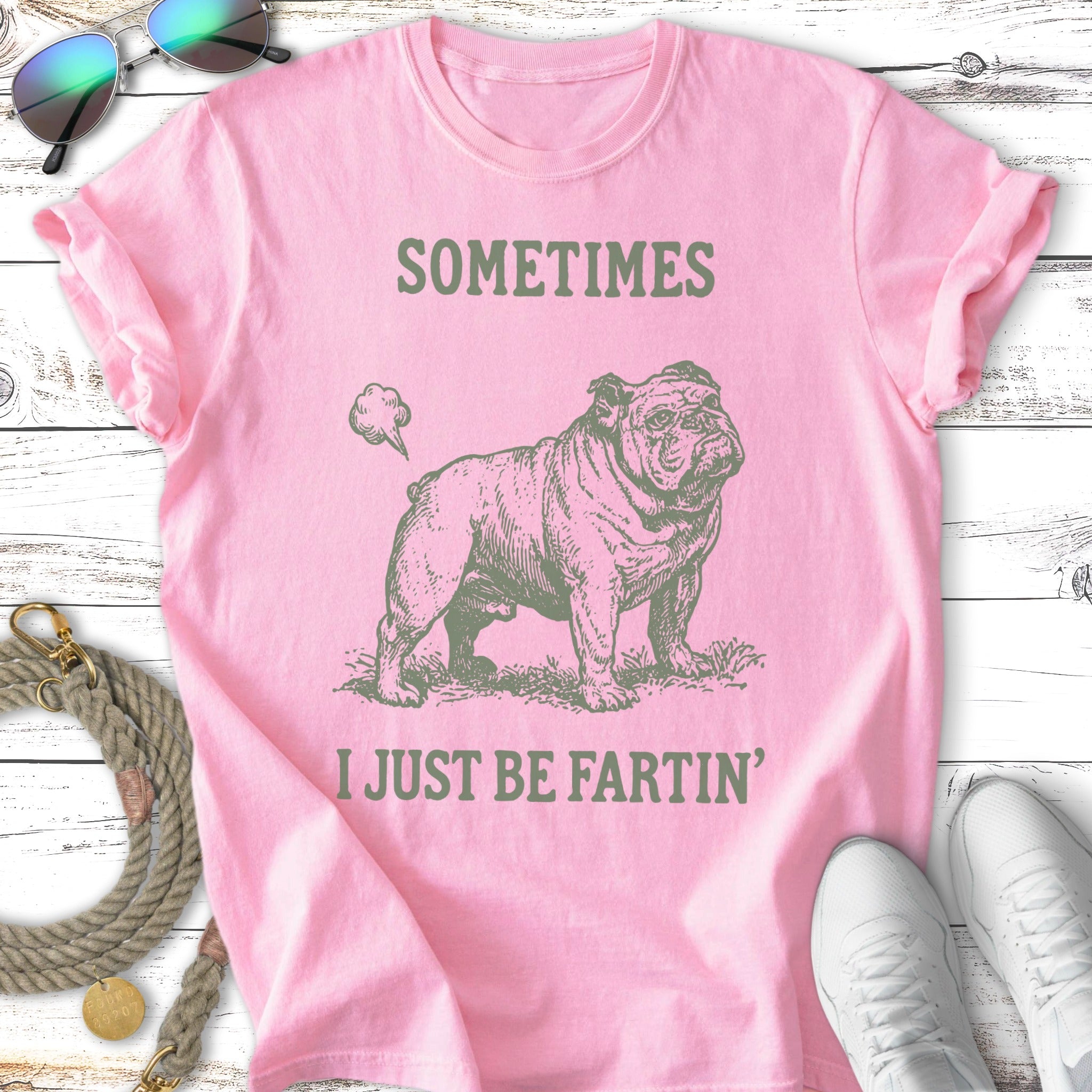 Pink t-shirt with a bulldog graphic and text "SOMETIMES I JUST BE FARTIN'".