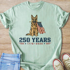 German Shepherd holding American flag with text "250 YEARS 1776-2026".