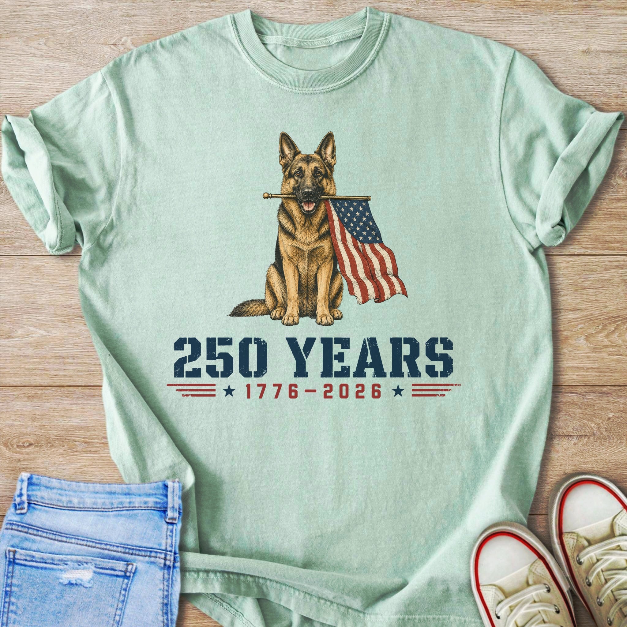 German Shepherd holding American flag with text "250 YEARS 1776-2026".