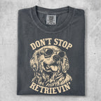 Dark grey t-shirt with graphic of Golden Retriever wearing sunglasses and text "DON'T STOP RETRIEVIN'".