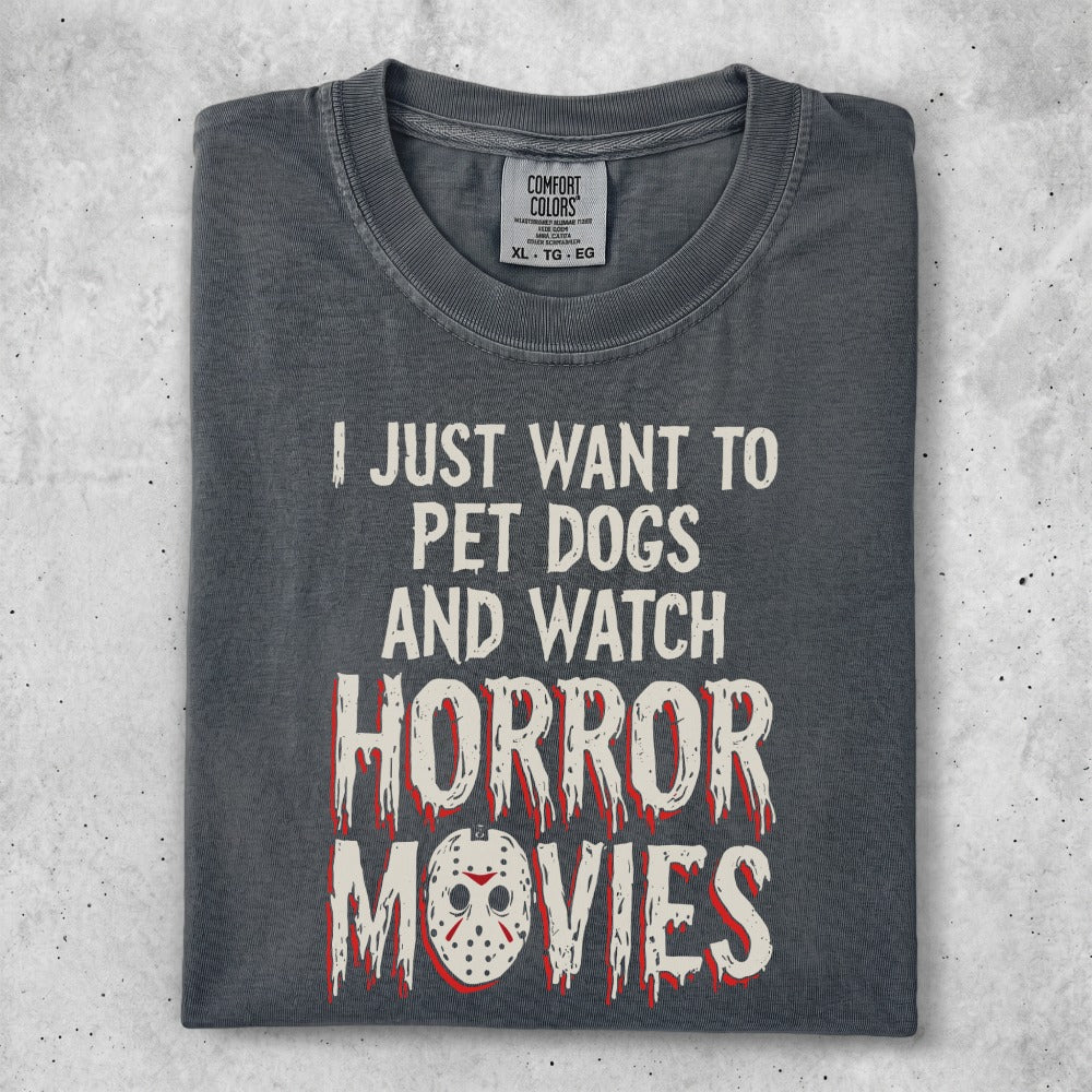 Dark t-shirt with "I JUST WANT TO PET DOGS AND WATCH HORROR MOVIES" text.