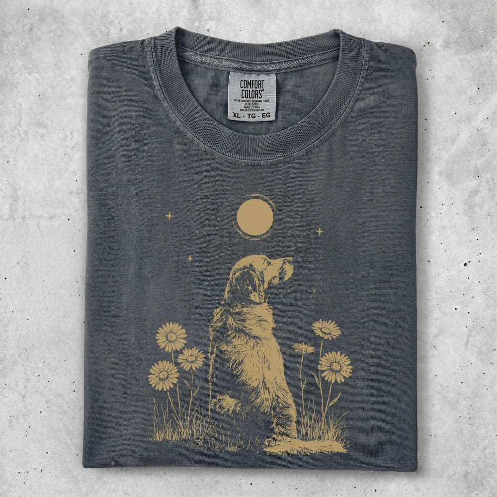 Golden Retriever sitting in a field of daisies with a moon above.