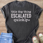 Dark gray t-shirt with "this dog thing ESCALATED quickly" and paw print.