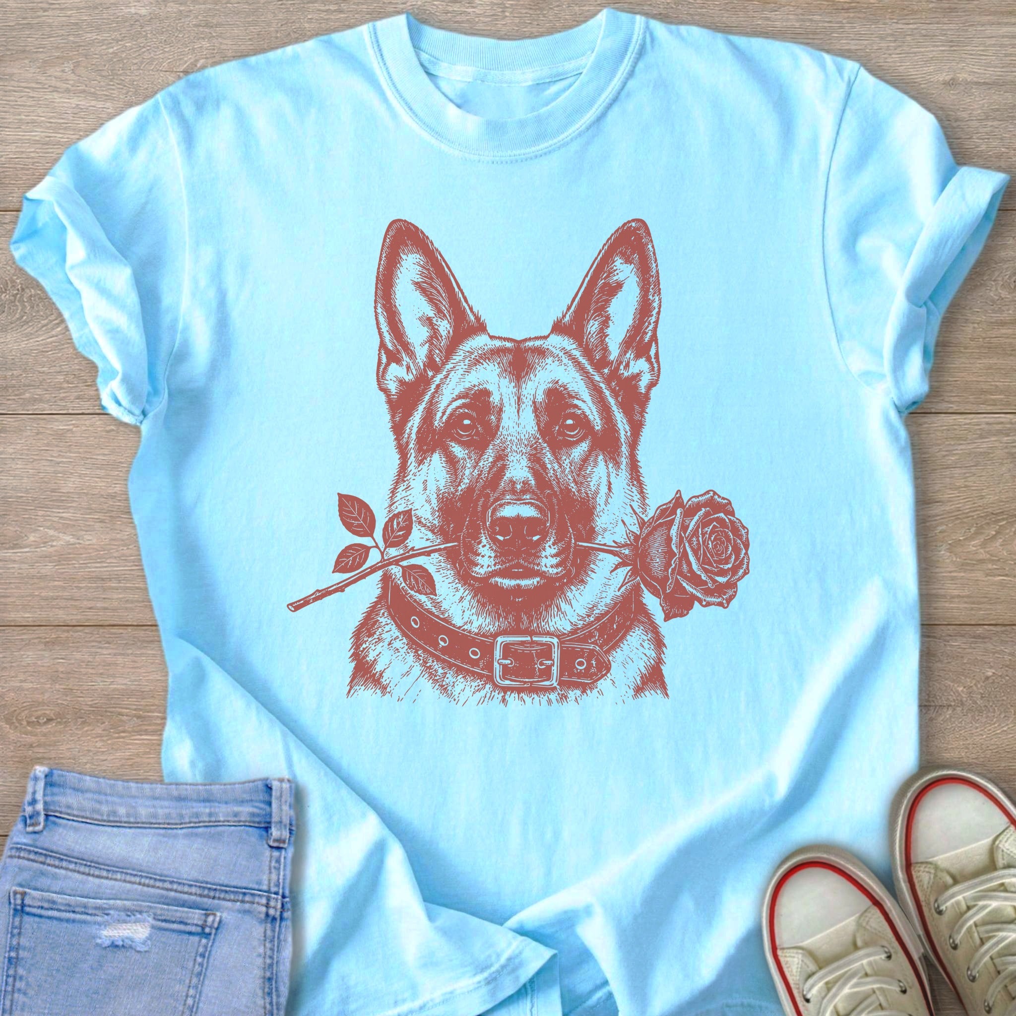 Light blue t-shirt with a graphic of a German Shepherd holding a rose in its mouth.