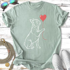 White outline of a French bulldog holding a red heart balloon.